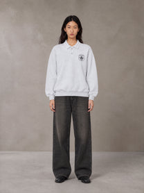 Model wearing the SM Royal Emblem Sweatshirt in Floral Grey, front view.