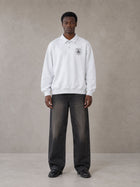 Model wearing the SM Royal Emblem Sweatshirt in Floral Grey, front view.