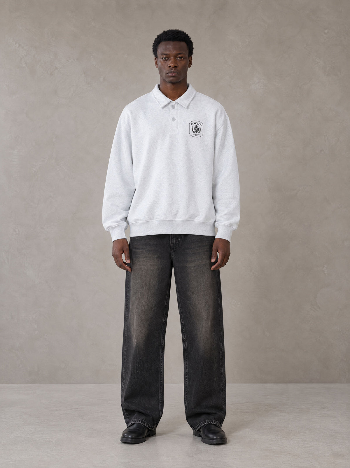 Model wearing the SM Royal Emblem Sweatshirt in Floral Grey, front view.