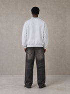 Model wearing the SM Royal Emblem Sweatshirt in Floral Grey, rear view.