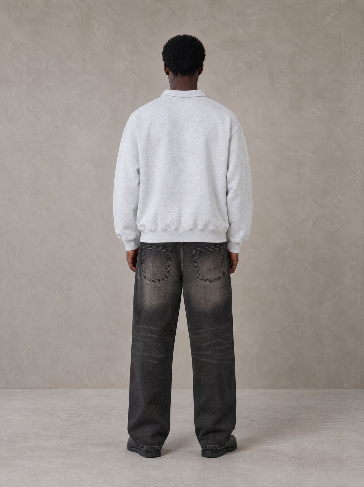 Model wearing the SM Royal Emblem Sweatshirt in Floral Grey, rear view.