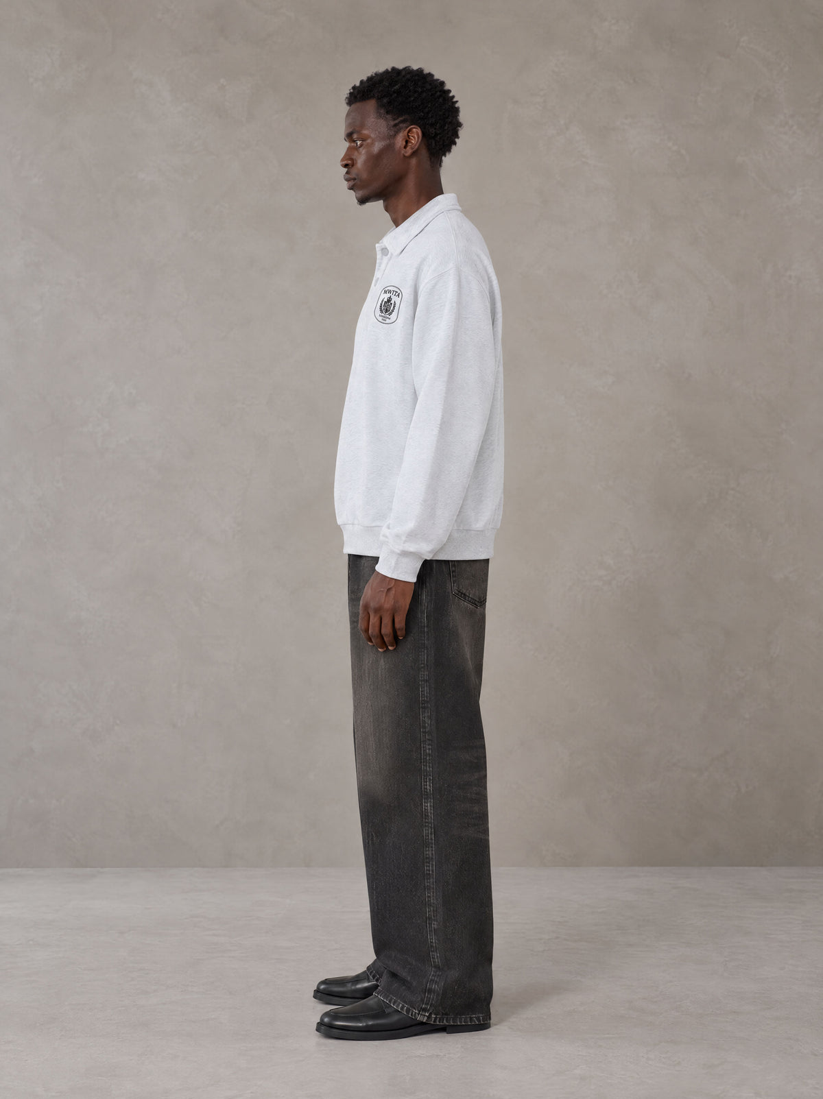 Model wearing the SM Royal Emblem Sweatshirt in Floral Grey, side profile.