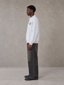 Model wearing the SM Royal Emblem Sweatshirt in Floral Grey, side profile.