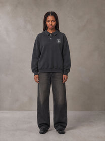 Model wearing the SM Royal Emblem Sweatshirt in Deep Charcoal, front view.