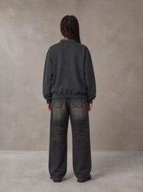 Model wearing the SM Royal Emblem Sweatshirt in Deep Charcoal, rear view.
