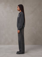 Model wearing the SM Royal Emblem Sweatshirt in Deep Charcoal, side profile.