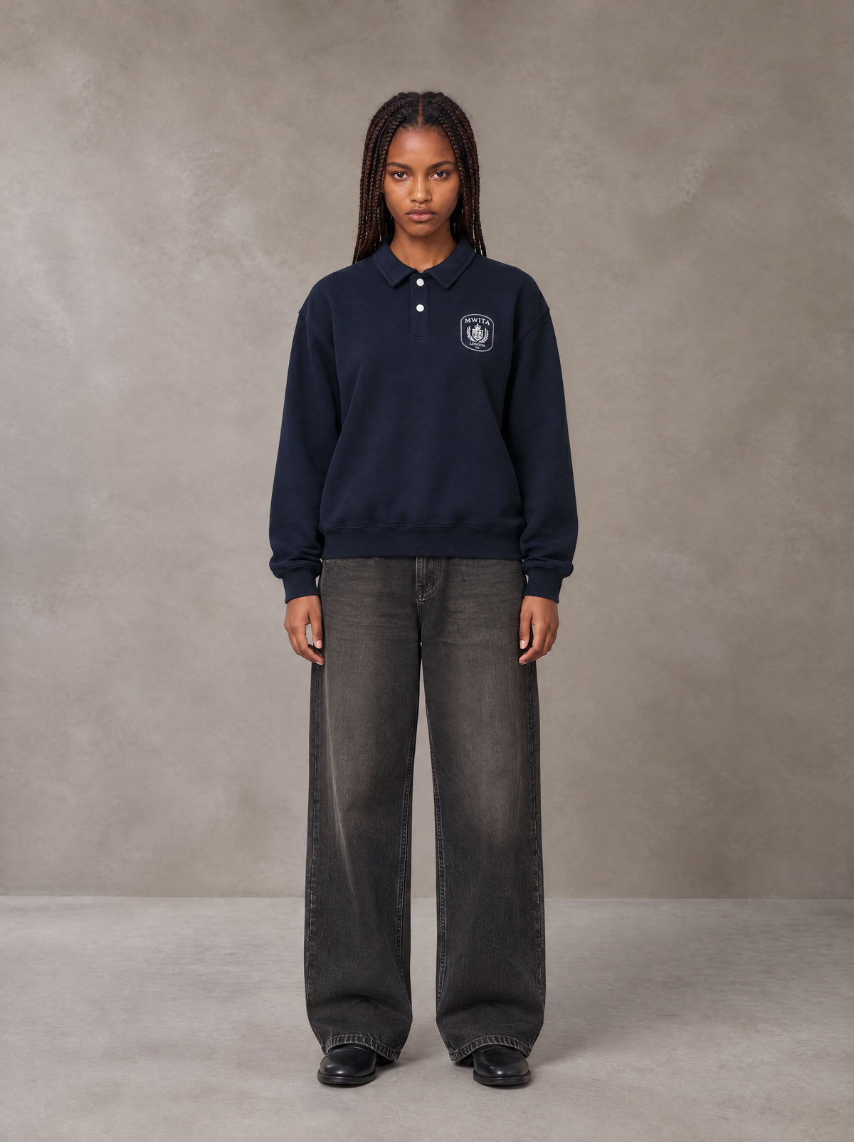 Model wearing the SM Royal Emblem Sweatshirt in Oxford Navy, front view.
