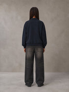 Model wearing the SM Royal Emblem Sweatshirt in Oxford Navy, rear view.