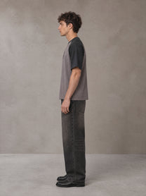 Model wearing the SM Royal Emblem T-shirt in Coffee Grey, side profile.