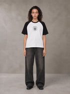 Model wearing the SM Royal Emblem T-shirt in Lucent White, front view.