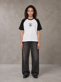 Model wearing the SM Royal Emblem T-shirt in Lucent White, front view.