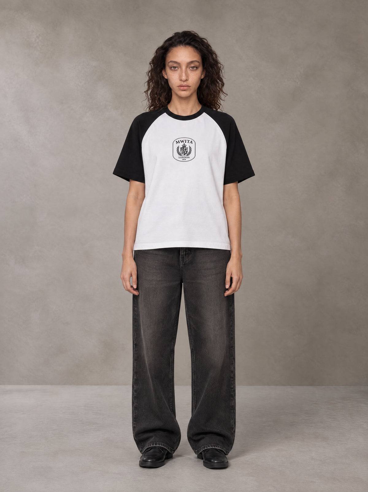 Model wearing the SM Royal Emblem T-shirt in Lucent White, front view.