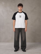 Model wearing the SM Royal Emblem T-shirt in Lucent White, front view.