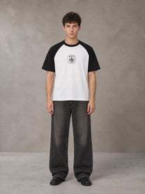 Model wearing the SM Royal Emblem T-shirt in Lucent White, front view.