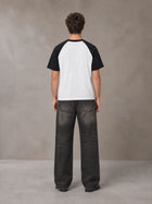Model wearing the SM Royal Emblem T-shirt in Lucent White, rear view.