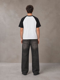 Model wearing the SM Royal Emblem T-shirt in Lucent White, rear view.