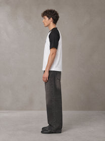 Model wearing the SM Royal Emblem T-shirt in Lucent White, side profile.