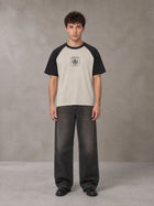 Model wearing the SM Royal Emblem T-shirt in Oatmeal Cookie, front view.