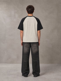 Model wearing the SM Royal Emblem T-shirt in Oatmeal Cookie, rear view.
