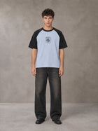 Model wearing the SM Royal Emblem T-shirt in Powder Blue, front view.