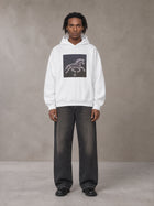 Model wearing the SM Celestial Charge Hoodie in Lucent White, front view.