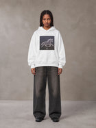 Model wearing the SM Celestial Charge Hoodie in Lucent White, front view.