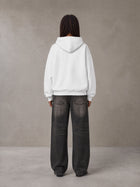 Model wearing the SM Celestial Charge Hoodie in Lucent White, rear view.