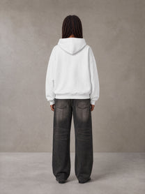 Model wearing the SM Celestial Charge Hoodie in Lucent White, rear view.