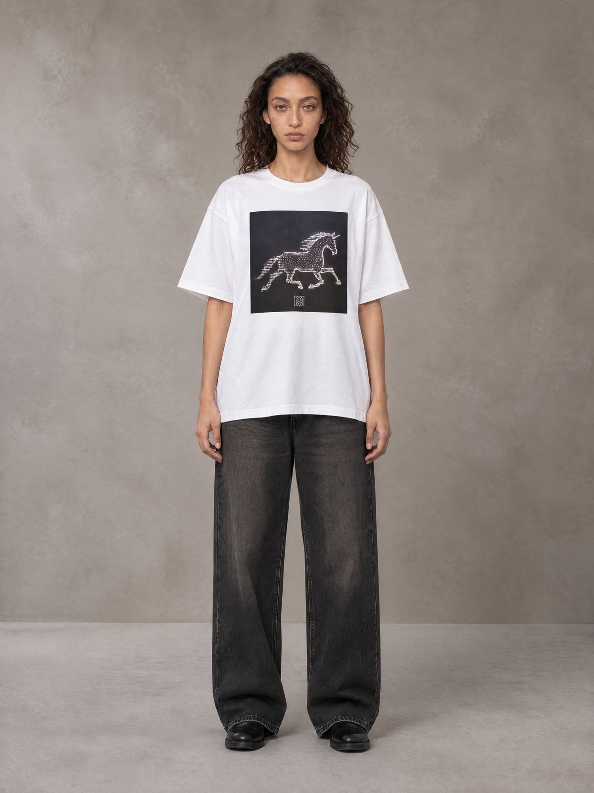 Model wearing the SM Celestial Charge T-shirt in Lucent White, front view.