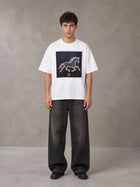 Model wearing the SM Celestial Charge T-shirt in Lucent White, front view.