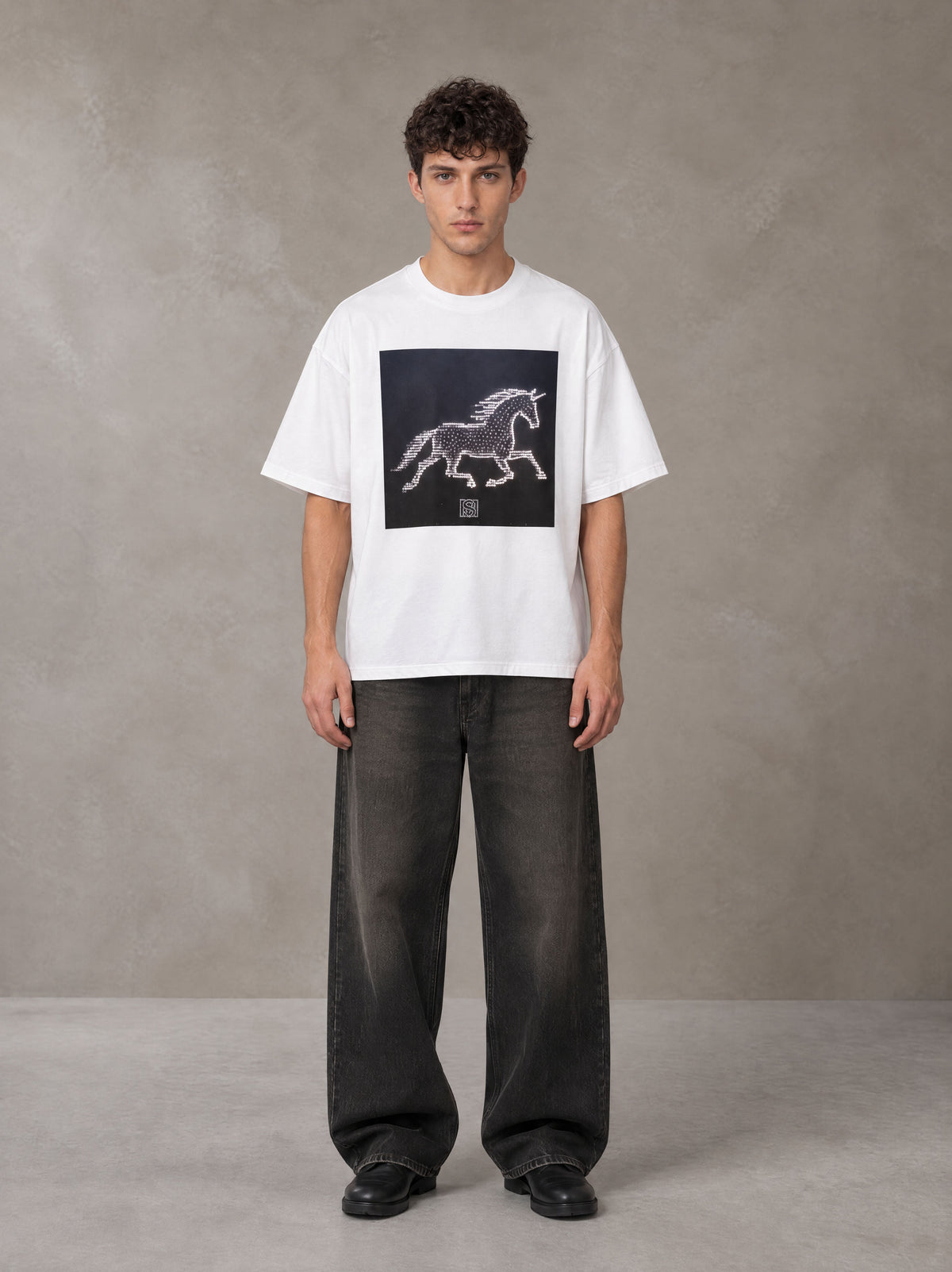 Model wearing the SM Celestial Charge T-shirt in Lucent White, front view.