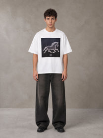 Model wearing the SM Celestial Charge T-shirt in Lucent White, front view.