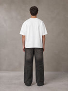 Model wearing the SM Celestial Charge T-shirt in Lucent White, rear view.