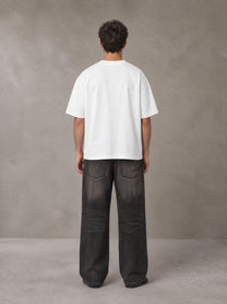 Model wearing the SM Celestial Charge T-shirt in Lucent White, rear view.