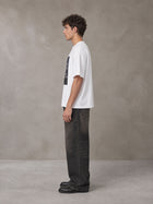 Model wearing the SM Celestial Charge T-shirt in Lucent White, side profile.
