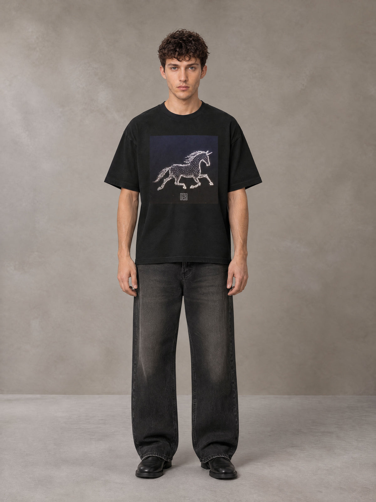 Model wearing the SM Celestial Charge T-shirt in Midnight Black, front view.