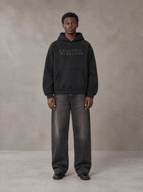 Model wearing the SM Clip Hoodie in Midnight Black, front view.