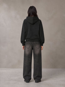 Model wearing the SM Clip Hoodie in Midnight Black, rear view.