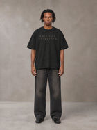 Model wearing the SM Clip T-shirt in Midnight Black, front view.