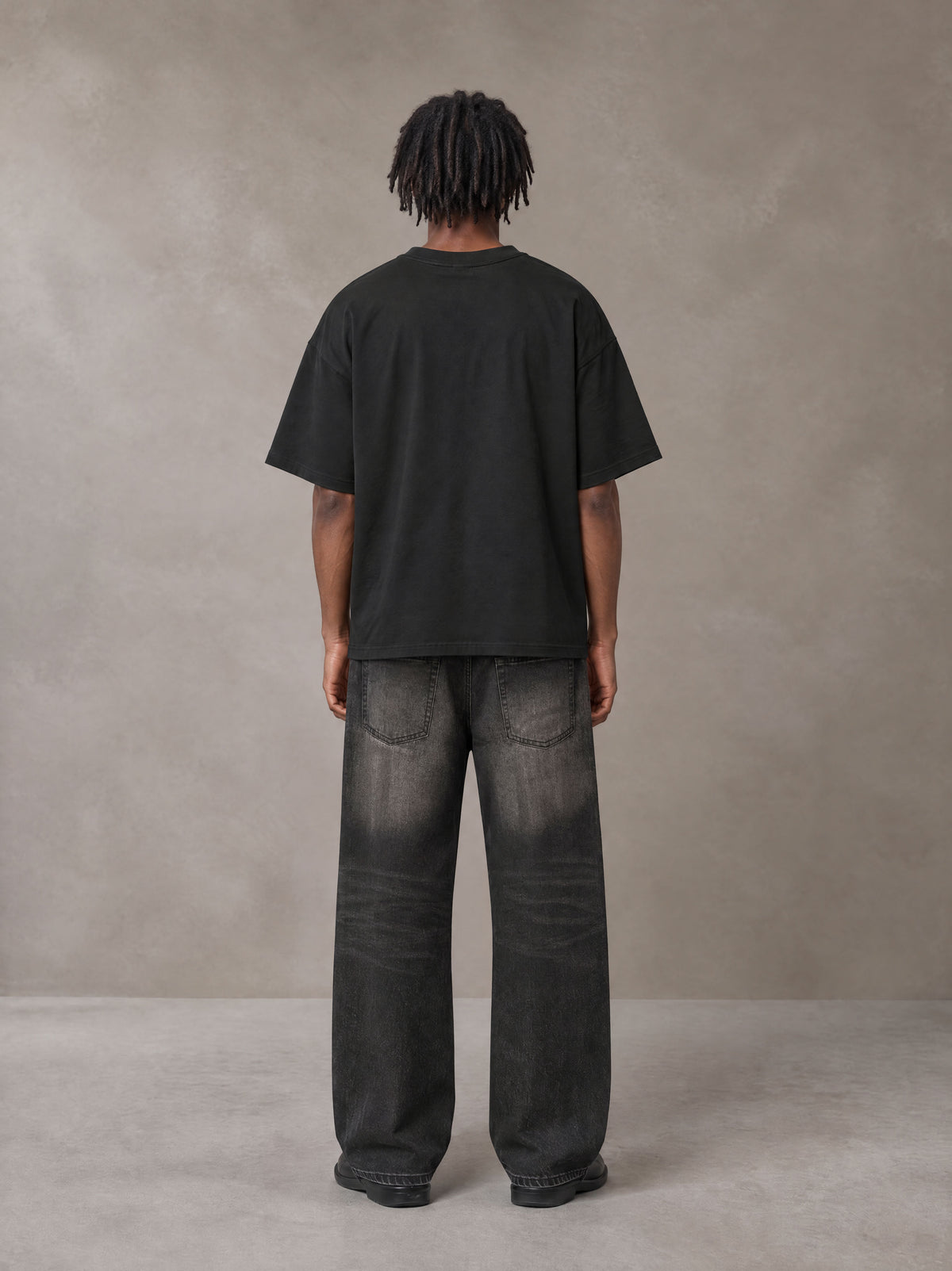 Model wearing the SM Clip T-shirt in Midnight Black, rear view.