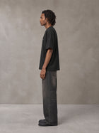 Model wearing the SM Clip T-shirt in Midnight Black, side profile.