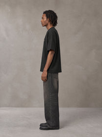 Model wearing the SM Clip T-shirt in Midnight Black, side profile.