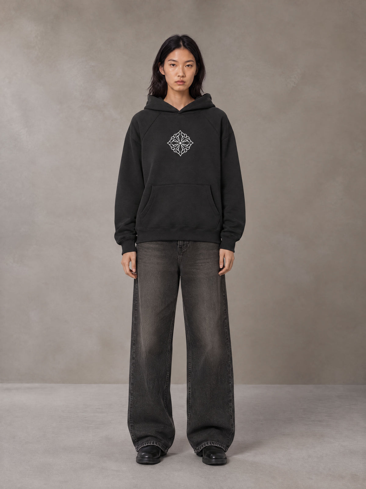 Model wearing the SM Fleur Hoodie in Midnight Black, front view.