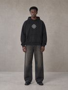 Model wearing the SM Fleur Hoodie in Midnight Black, front view.
