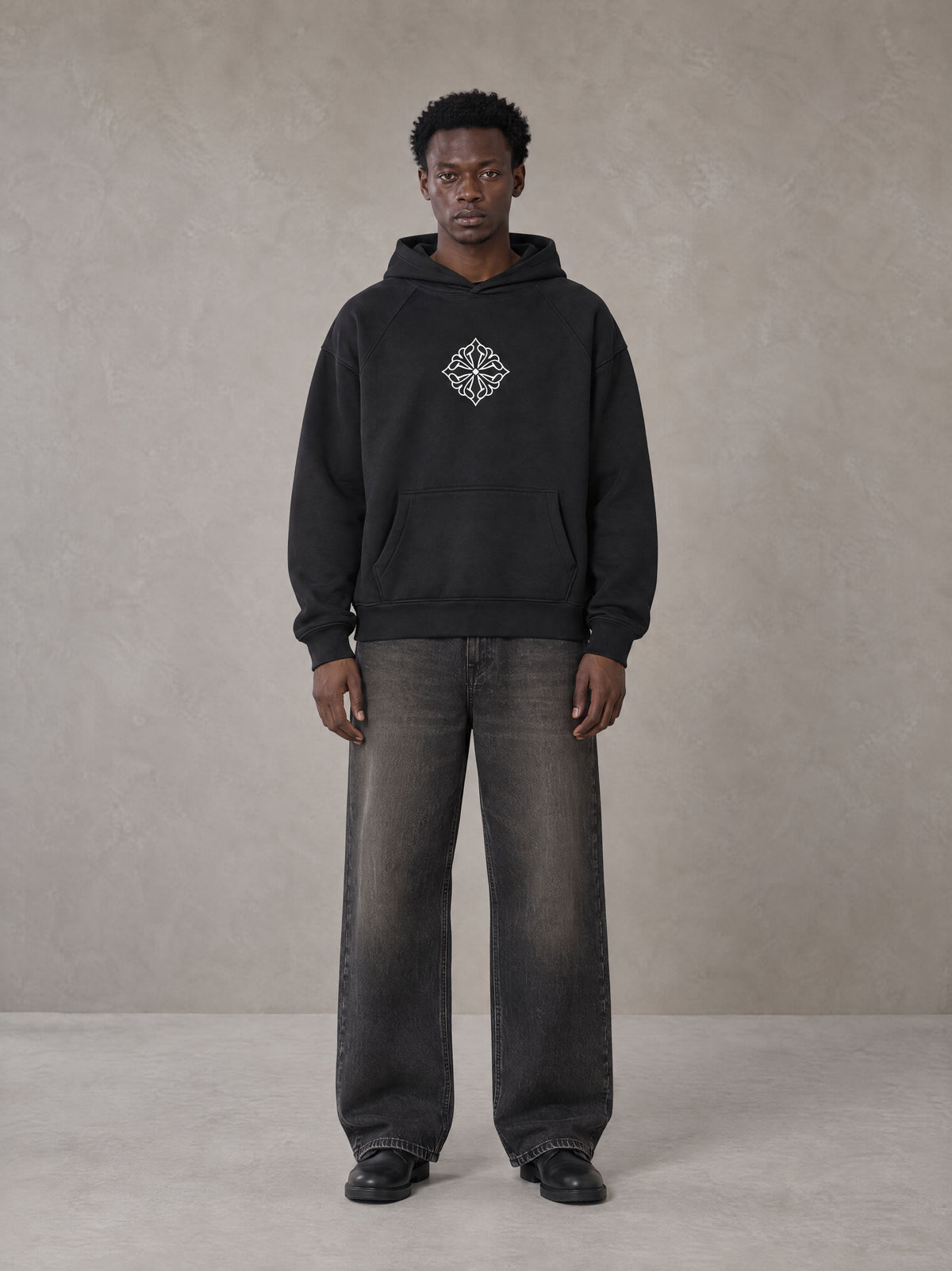 Model wearing the SM Fleur Hoodie in Midnight Black, front view.