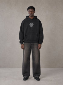 Model wearing the SM Fleur Hoodie in Midnight Black, front view.