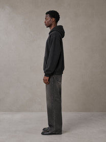 Model wearing the SM Fleur Hoodie in Midnight Black, side profile.