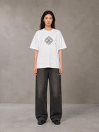 Model wearing the SM Fleur T-shirt in Lucent White, front view.
