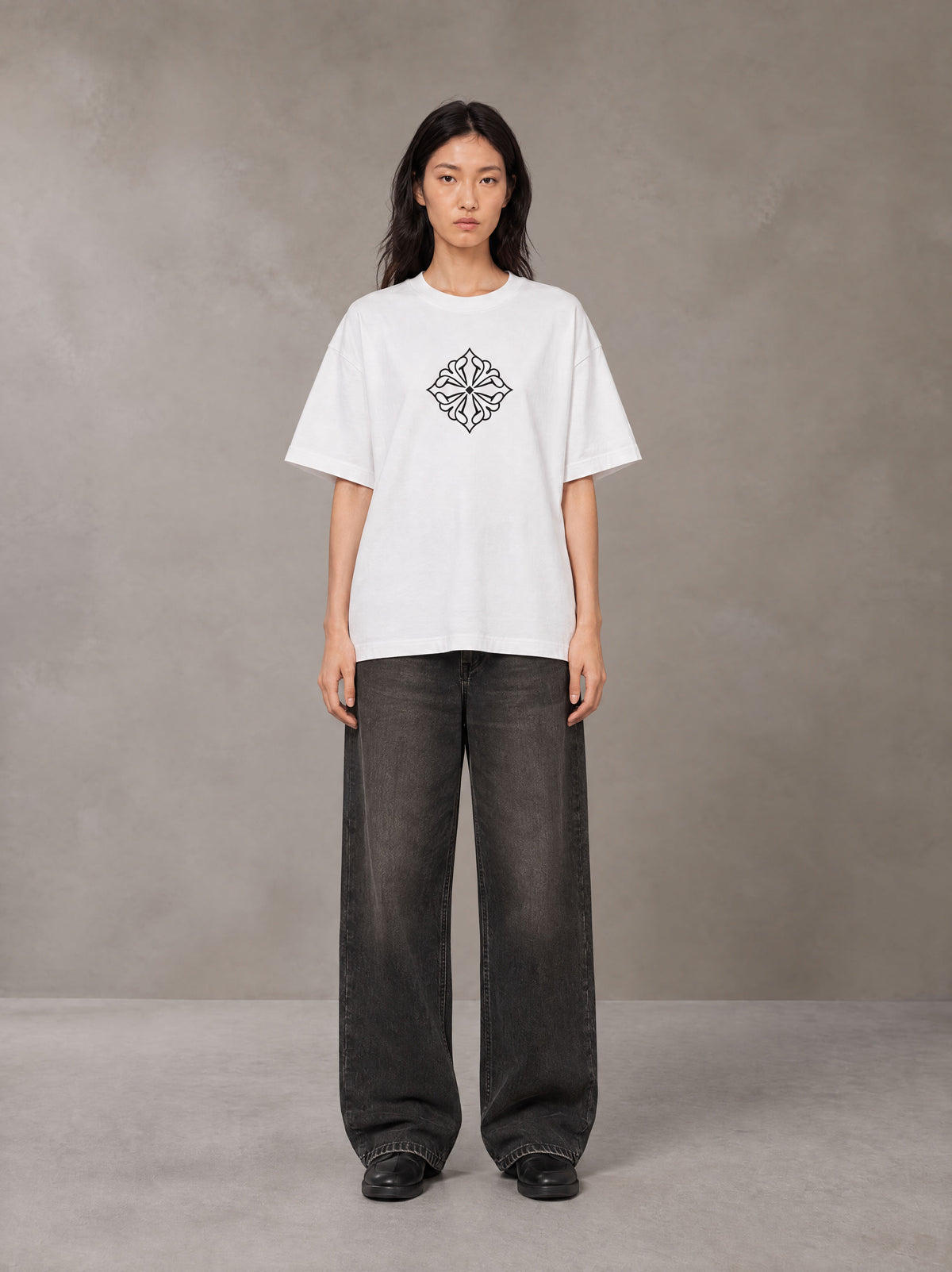 Model wearing the SM Fleur T-shirt in Lucent White, front view.
