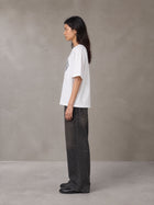 Model wearing the SM Fleur T-shirt in Lucent White, side profile.